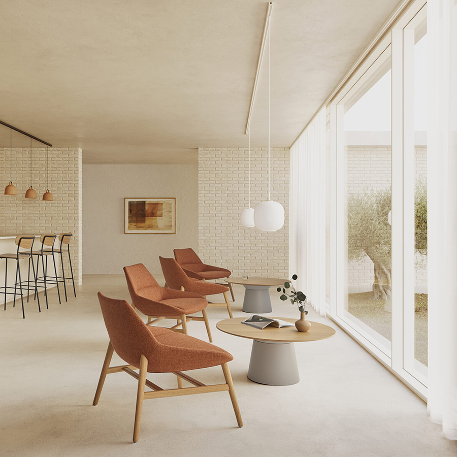 Mesa auxiliar essens occasional ambiente con sillas naranjas.