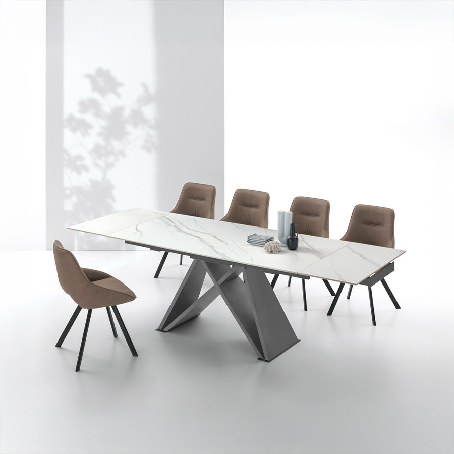 Mesa extensible Delta de la firma italiana Target Point, en acabado sobre carrara y patas argento y vista de ambiente.