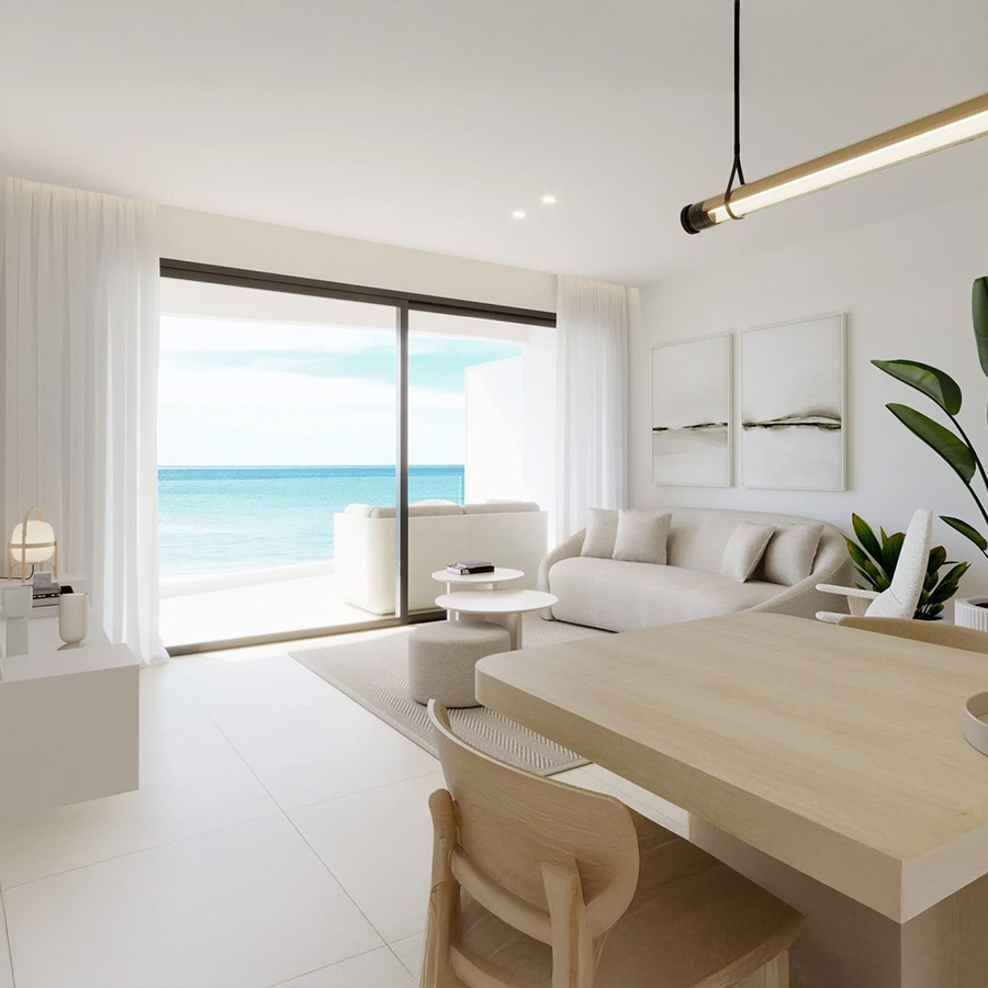 Sofá coral de la firma Temasdos en vista de ambiente de salón con vistas al mar.